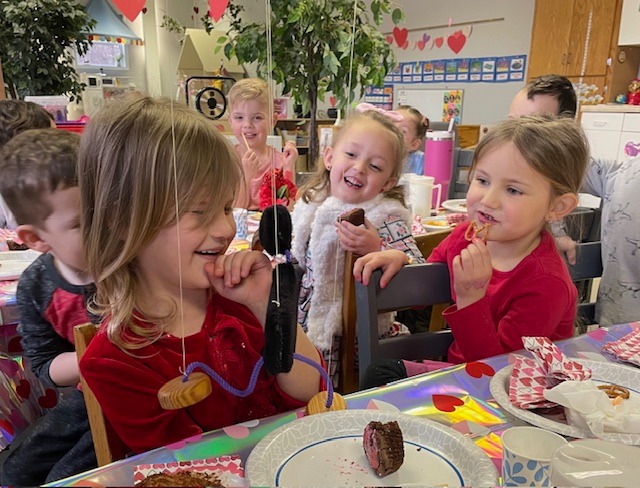 Children enjoying family-style lunch together
